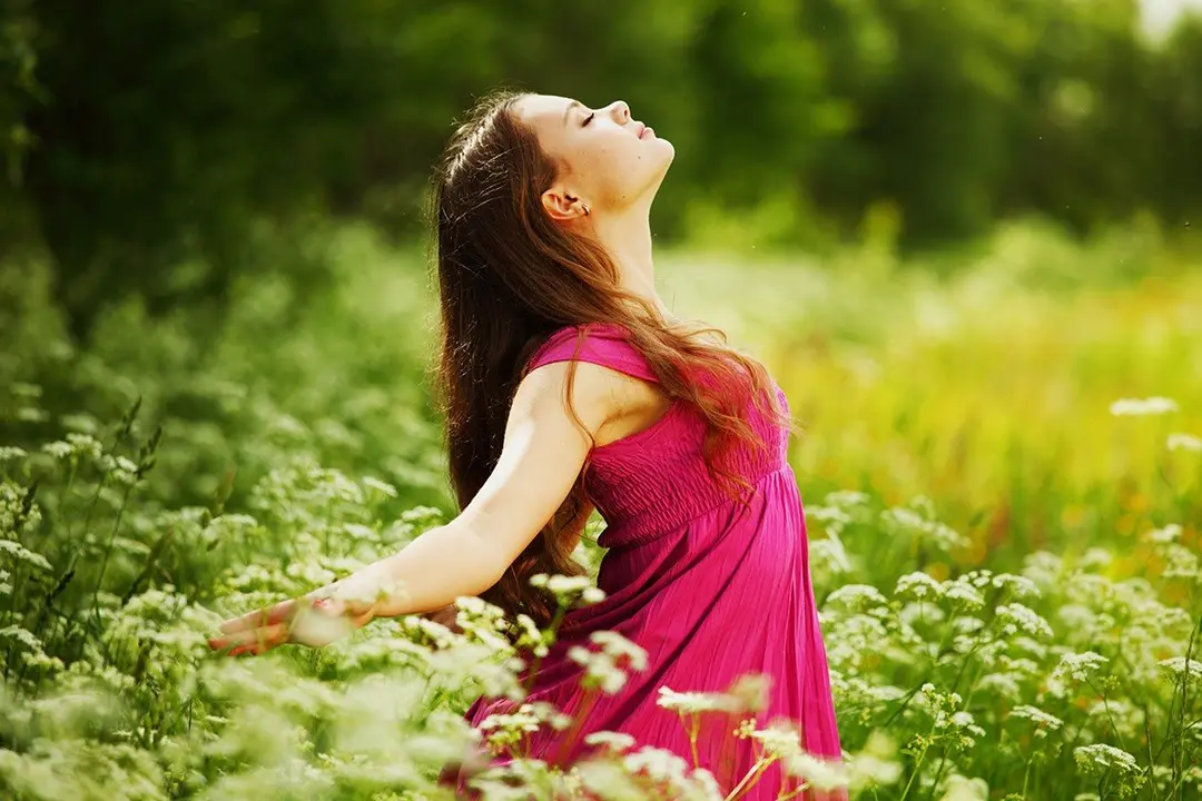 woman on green grass field feel freedom
