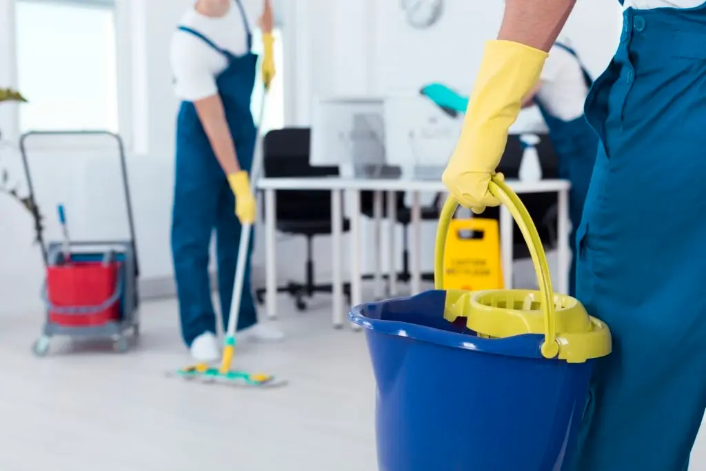 64167581 - close up of a man holding a mop bucket