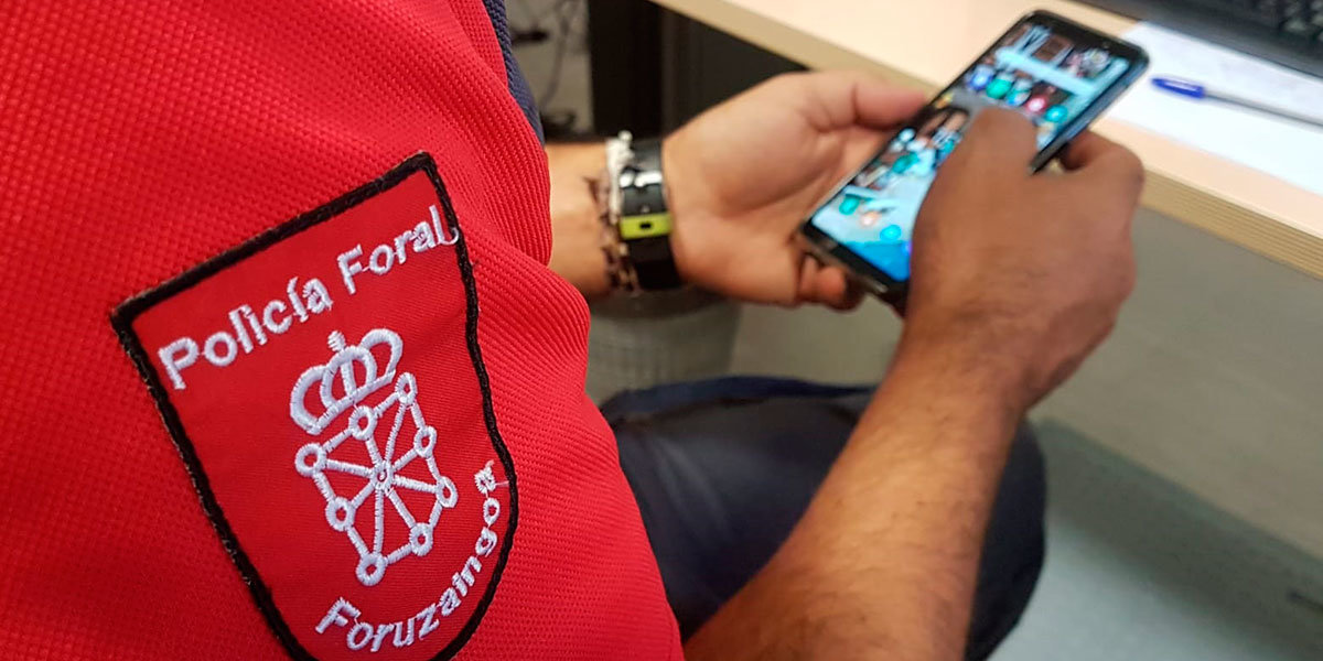Un Policía Foral comprueba en su móvil las redes sociales