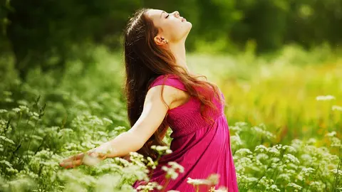 woman on green grass field feel freedom
