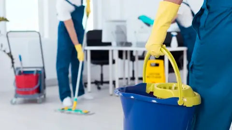 64167581 - close up of a man holding a mop bucket