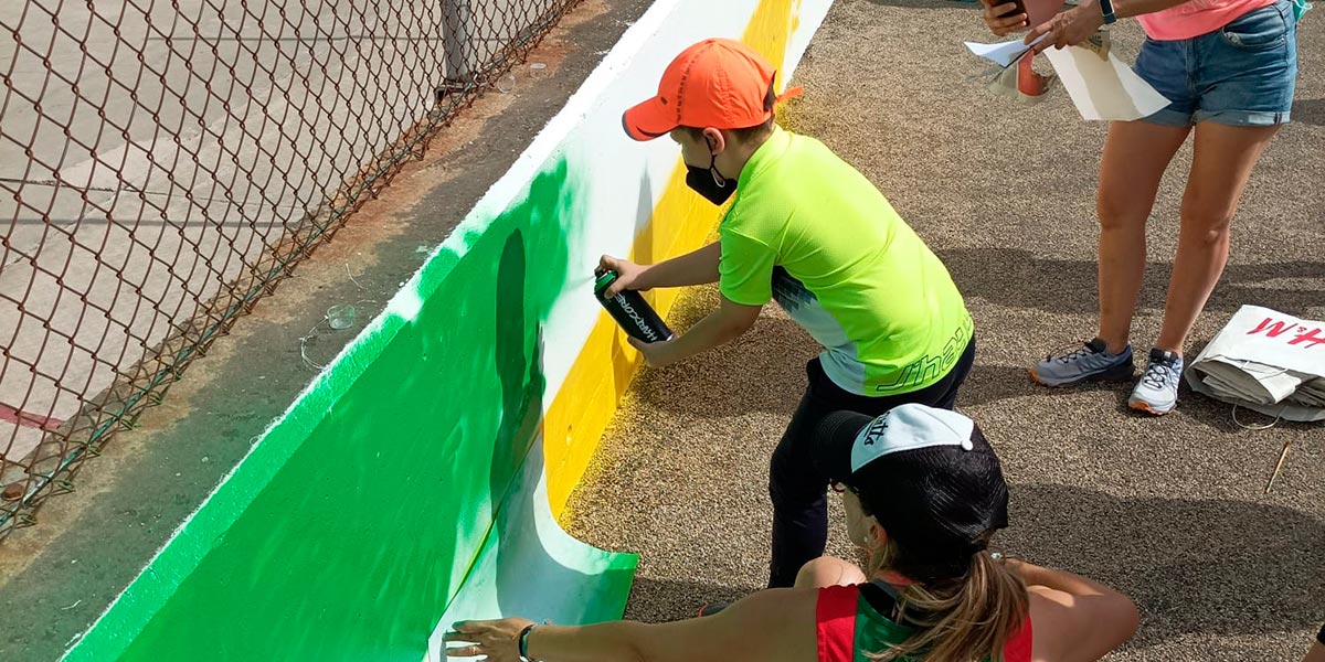 Gente de Fontellas pintando el mural de la entrada a su localidad